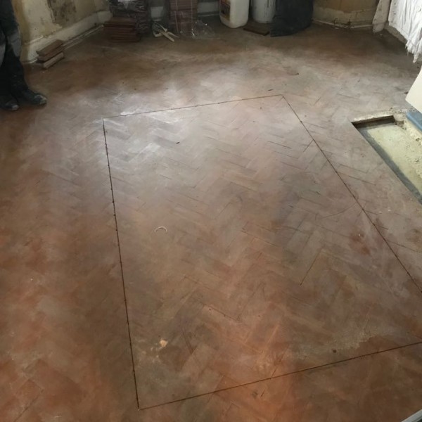Before -Pine parquet being prepared for a bespoke feature and sanding and sealing